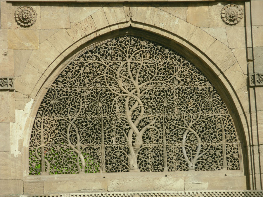Sidi syed mosque Jali Complex stone jali screen with tree of life design in pointed arch window.