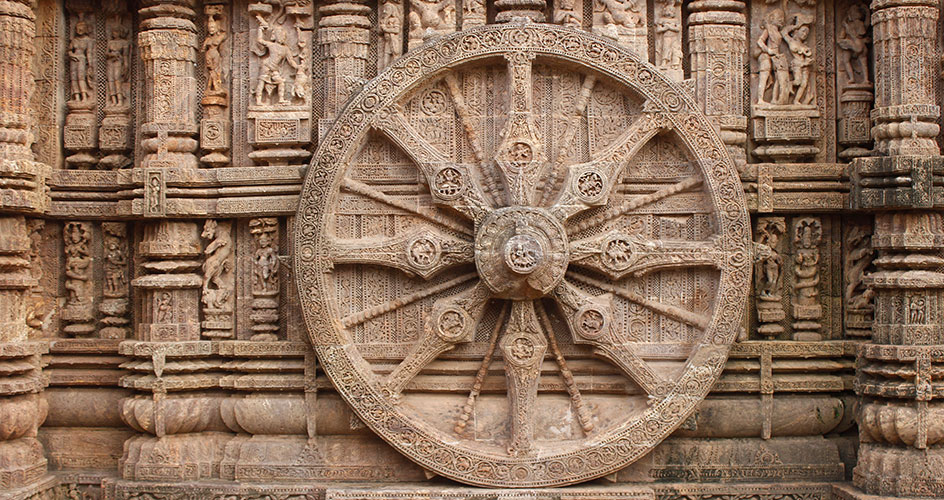 Chariot wheel in stone chariots with radiating spokes, carved in relief on the exterior wall of the temple.
