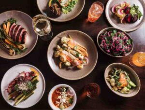 Selection of healthy gourmet vegetarian cuisine as well as delicious food served on wooden table as part of wellness food.